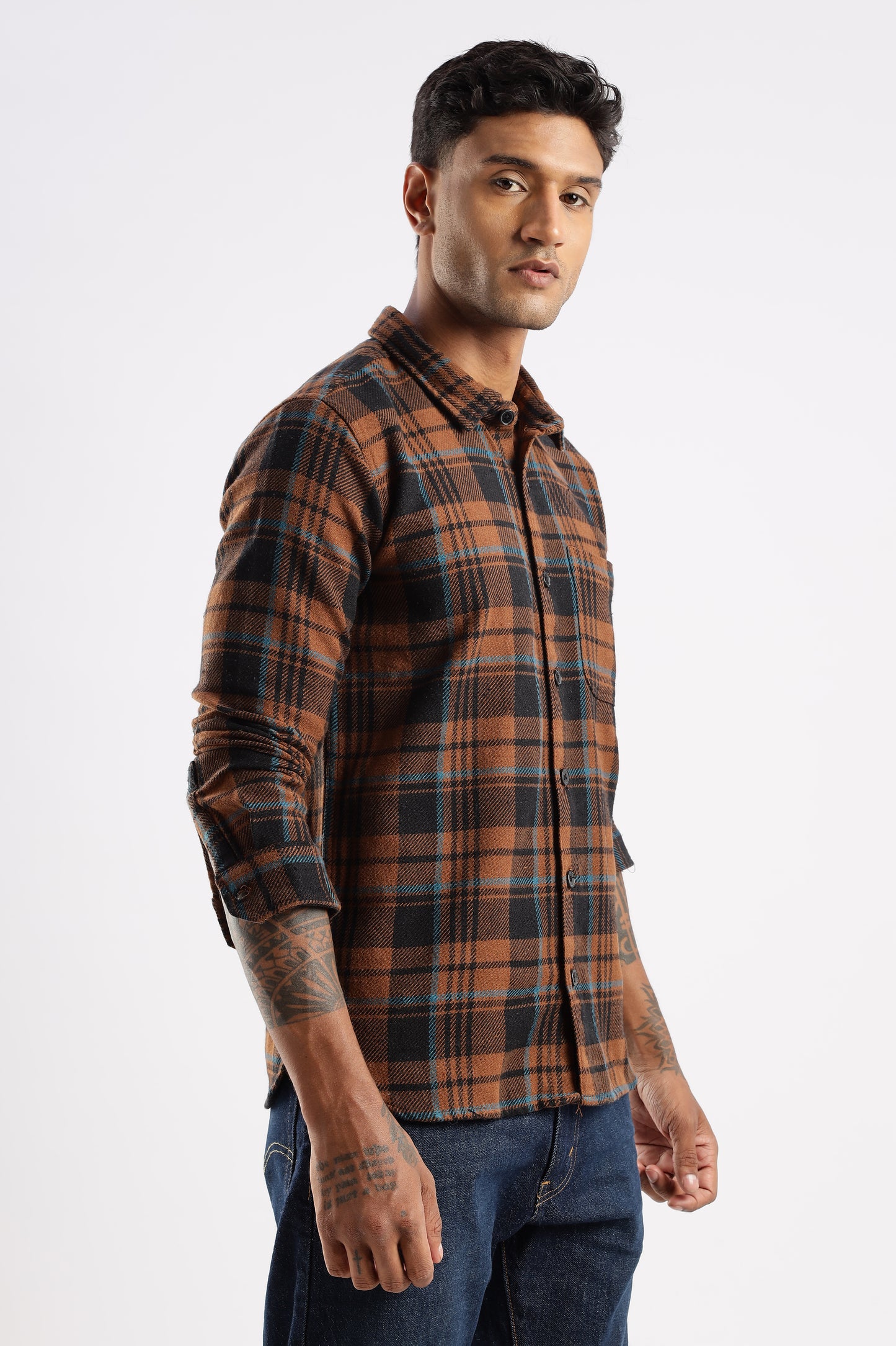 Outdoor lifestyle shot of model wearing Timberland Rust flannel shirt in autumn setting